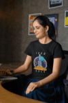 gildan-tee-mockup-of-a-smiling-woman-working-at-an-office-m31761 (1)